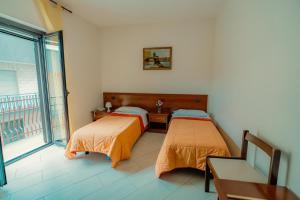 Ένα ή περισσότερα κρεβάτια σε δωμάτιο στο Albergo Settebello