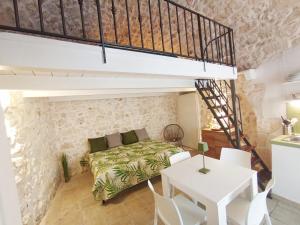 a bedroom with a bed and a table and chairs at LA SALVIA guest house in Ostuni