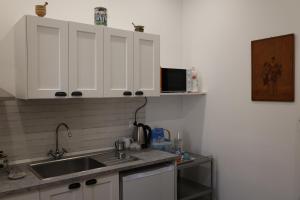 a kitchen with white cabinets and a sink at a Casa di Maria in Vieste +7 photos