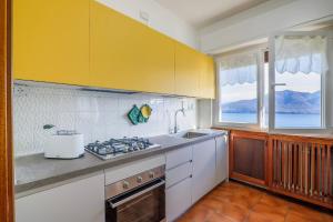 a kitchen with a sink and a stove top oven at Appartamento Valentina in Oggebbio +35 photos