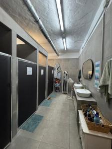 a large bathroom with a sink and a toilet at Medano Nest Hostel in El Médano