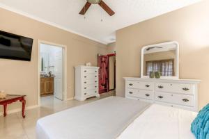 a bedroom with a white dresser and a mirror at Fairview Near AC Hotel Kingston - FIWI in Kingston +22 photos