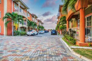 a cobblestone street in front of buildings with palm trees at Fairview Near AC Hotel Kingston - FIWI in Kingston