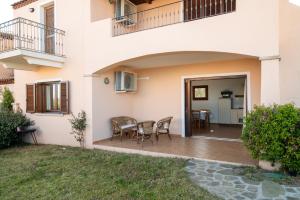 a patio in a house with a table and chairs at Bellosguardo 3, 8 - Klodge in Olbia