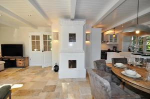 a living room with a table and a fireplace at Doppelhaushälfte SPO-Stern in Böhl