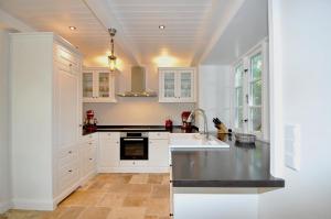 a kitchen with white cabinets and a sink at Doppelhaushälfte SPO-Stern in Böhl