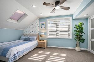 a bedroom with a bed and a ceiling fan at The Townline House in Union Pier