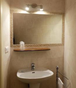 y baño con lavabo y espejo. en Albergo Bernini en Siena