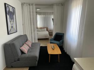 a living room with a couch and a table at Z - 4 Urban in Eilat