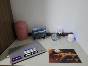 une table avec un ordinateur portable, un livre et un verre dans l'établissement Pousada Céu de Viracopos, à Campinas 28 autres photos