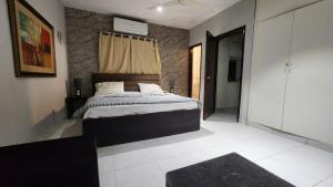a bedroom with a large bed in a room at Karachi cozy corner in Dargai