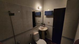 a bathroom with a toilet and a sink at Karachi cozy corner in Dargai