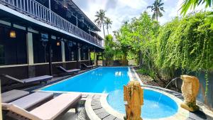 a swimming pool in front of a building at Gili Buana Hostel & Backpackers Gili Air in Gili Islands +91 photos