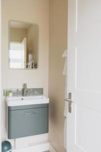 a bathroom with a sink and a mirror at White Hart Inn in Brightling