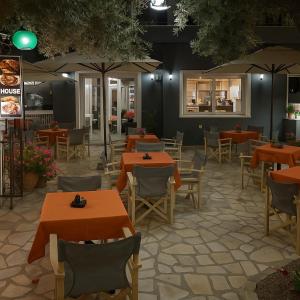 a restaurant with tables and chairs and umbrellas at Blue Lake Holiday Homes - Keri Summer Escape in Keri