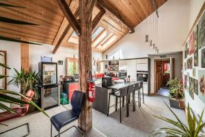 an open kitchen and living room with wooden ceilings at Chalet Elisthur in Saint-Jean-dʼAulps