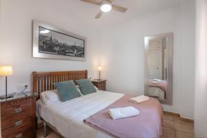a bedroom with a large bed and a mirror at Apartamento Palo Verde Golf in Islantilla +16 photos