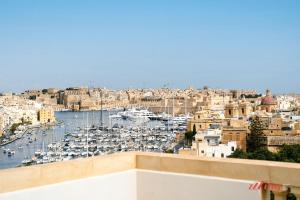 a view of a harbor with boats in the water at Yolanda Boutique Suites by Zzzing in Birgu