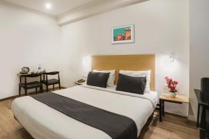 Ένα ή περισσότερα κρεβάτια σε δωμάτιο στο Townhouse Rajdhani Residency