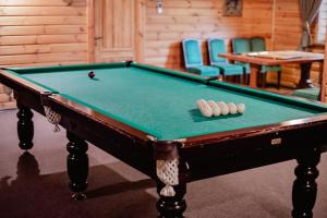 a pool table with two balls in a room at Hotel Bannyi Dvir in Uzyn