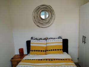 a bedroom with a bed with a mirror on the wall at accommodation à la ferme in Lubersac