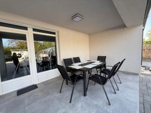 a dining room with a table and chairs at LG Apartman Siófok in Siófok +34 photos