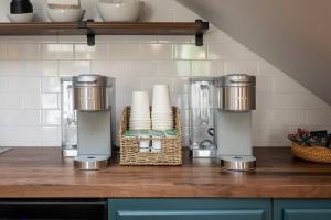 a kitchen counter with two appliances on a counter top at The Legacy Suites Collection Full Property Rental in Luray