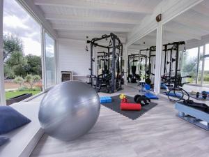 a gym with a large exercise ball in the middle at Villa Bernardi in Ostuni
