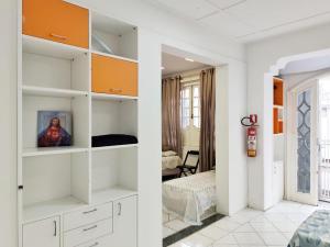 a room with white shelves and a bedroom at Casa Nossa Senhora de Nazaré 2 in Belém