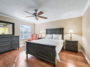 a bedroom with a bed and a ceiling fan at 1095 Z2A VILLAGE OF SUMMERHILL by REMAX Premier in The Villages