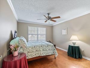 a bedroom with a bed and a ceiling fan at 1095 Z2A VILLAGE OF SUMMERHILL by REMAX Premier in The Villages