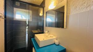 un baño con lavabo y espejo en Studio Cocody 8 LUMIO, en Lumio