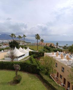 an aerial view of a resort with tents and palm trees at Vox Maris by Wyndham Costa del Sol in Fuengirola