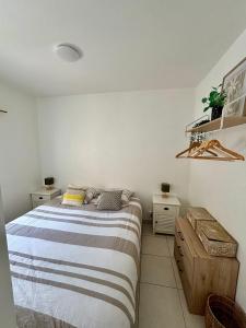 a bedroom with a bed and two night stands at Joli Appartement au centre de carry le rouet in Carry-le-Rouet