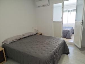 a bedroom with a bed in a room at Bungalow con barbacoa in Torrevieja