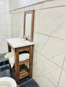 a bathroom with a sink and a mirror at Hostel La Juana - Ezeiza - in Ezeiza