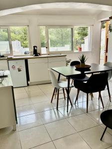 a kitchen and dining room with a table and chairs at Joli Appartement au centre de carry le rouet in Carry-le-Rouet +7 photos