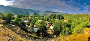 an aerial view of a village in the mountains at Bujtina Bashllari in Zvarisht