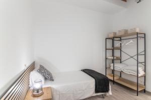a bedroom with a bed and a book shelf at La Lajita in Tafira Baja