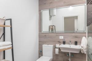 a bathroom with a sink and a toilet and a mirror at La Lajita in Tafira Baja +22 photos