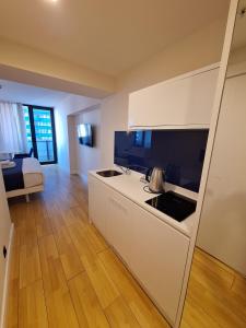 a kitchen with a stove and a counter top at Orbi City rooms 1039 in Batumi