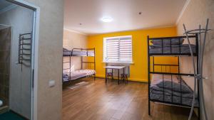a room with three bunk beds and a window at 4ua-хостел in Bratslav
