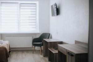 a living room with a chair and a window at 4ua-хостел in Bratslav