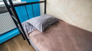 a pillow sitting on a bed in a room at 4ua-хостел in Bratslav +3 photos