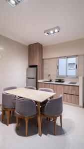 a kitchen with a table and chairs in a room at Departamento de lujo en centro de casco histórico in San Miguel de Tucumán