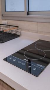 a stove top oven sitting on top of a kitchen counter at Departamento de lujo en centro de casco histórico in San Miguel de Tucumán +13 photos