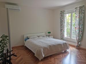 a bedroom with a bed and a large window at IstraCycle in Lucija