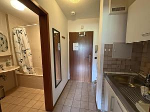 a bathroom with a sink and a toilet and a tub at Gschwendtnerhof App10 KrausW in Aschau im Chiemgau