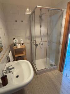 a bathroom with a shower and a sink at Le Muse apartment in Caserta +17 photos