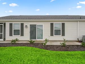 a house with a lawn in front of it at 1642 Z5 VILLAGE OF LAKE DENHAM by REMAX Premier in Leesburg